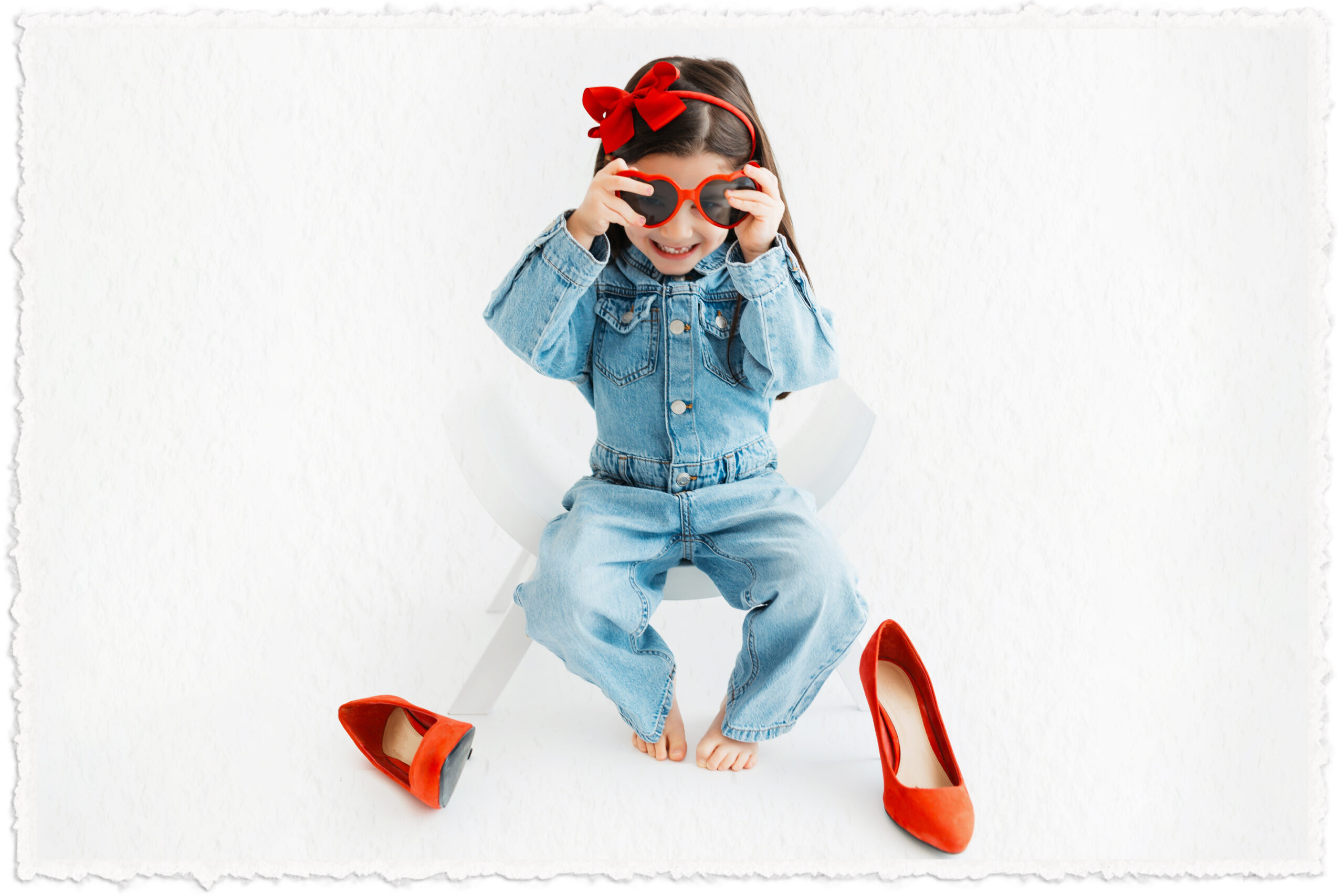girlwearingradsunglasses-sittingonachair-smallkid-herosectiononhomesite